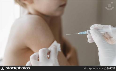 doctor with kid getting vaccine