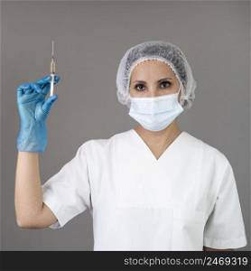 doctor with mask holding syringe