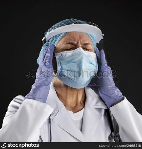 doctor with medical mask having headache