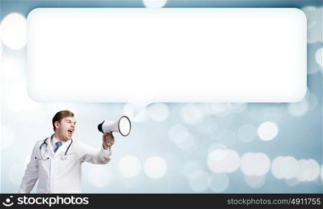 Doctor with megaphone. Young male doctor screaming in megaphone emotionally