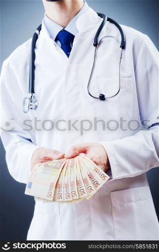 Doctor with money in studio