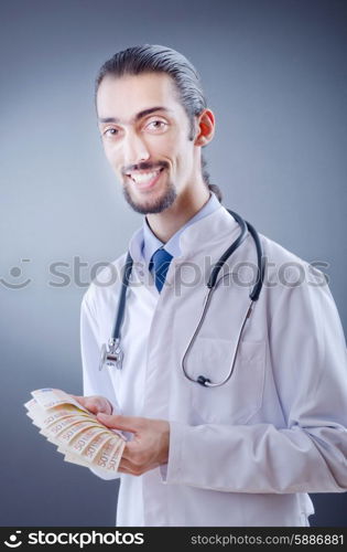 Doctor with money in studio