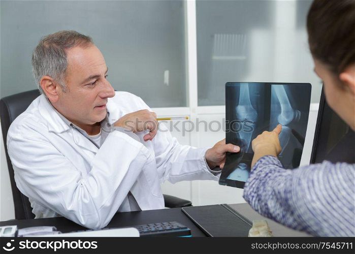 doctor with patient looking at x-ray
