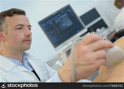 doctor with patient undergoing arm echography