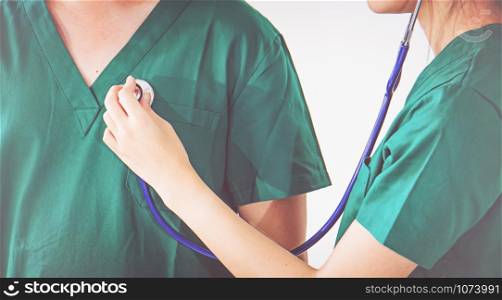 doctor with stethoscope examining heart