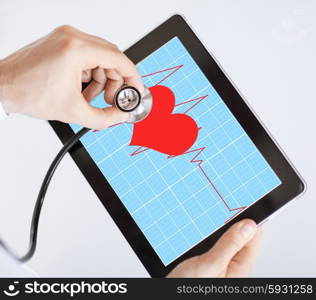 doctor with stethoscope listening heart beat on tablet pc. doctor listening to heart beat