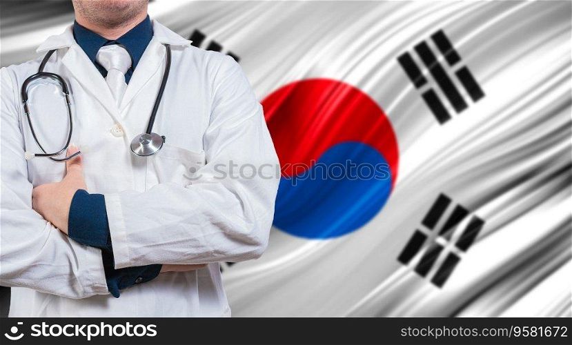 Doctor with stethoscope on South Korean flag. Doctor with crossed arms on South Korean flag. Medical health and care on South Korean flag