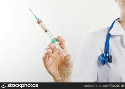 Doctor with syringe mid section