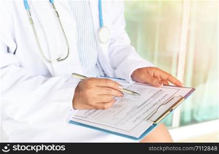 doctor woman asian note on medical record - medical examination report for diagnosis in the hospital / healthcare checks physician at work or nurse and patient are discussing about diagnosis