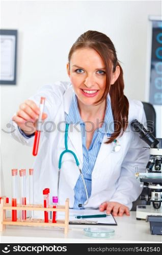 Doctor woman giving test tube&#xA;