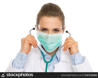 Doctor woman in mask using stethoscope