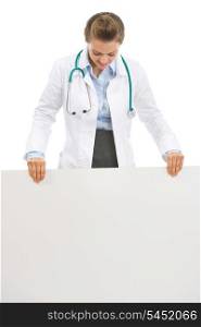 Doctor woman looking on blank billboard