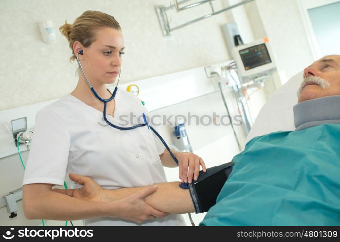 doctor woman measuring patient blood pressure