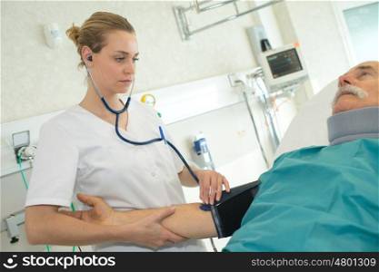 doctor woman measuring patient blood pressure