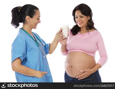 Doctor woman offering milk to beautiful pregnant woman