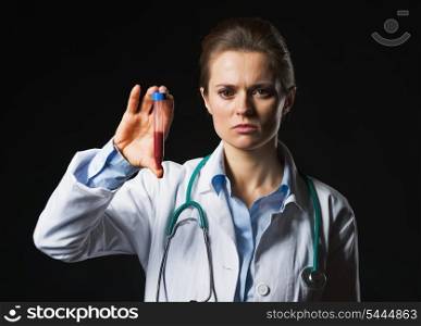 Doctor woman showing test tube on black background