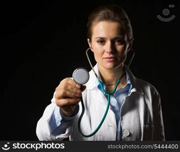 Doctor woman using stethoscope isolated on black