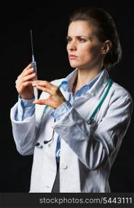 Doctor woman using syringe on black background