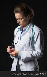 Doctor woman writing prescription isolated on black
