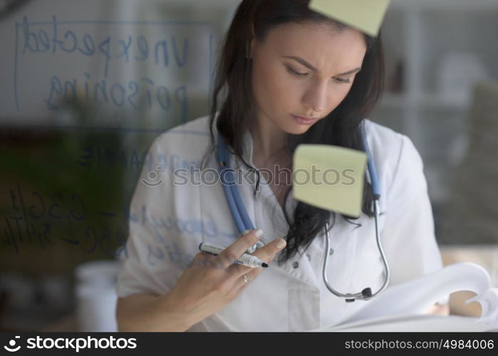 Doctor working at office with patient symptoms and test results