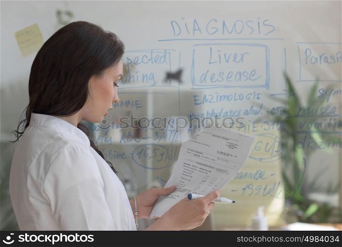 Doctor working at office with patient symptoms and test results
