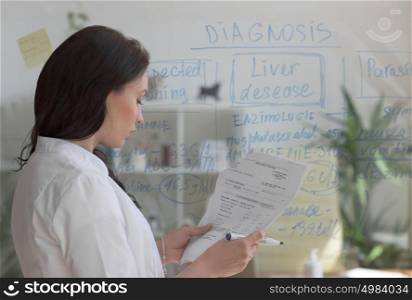 Doctor working at office with patient symptoms and test results