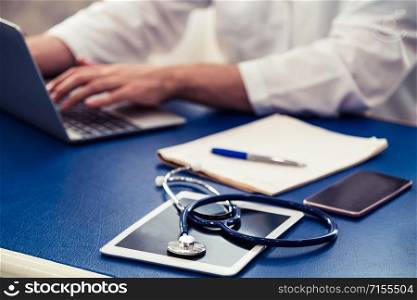 Doctor working in hospital office. Medical healthcare concept.