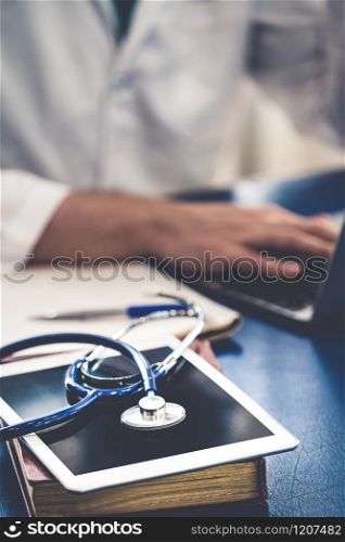 Doctor working in hospital office. Medical healthcare concept.. Doctor working in hospital office.