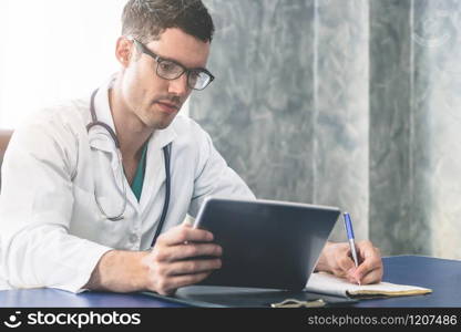 Doctor working in hospital office. Medical healthcare concept.. Doctor working in hospital office.