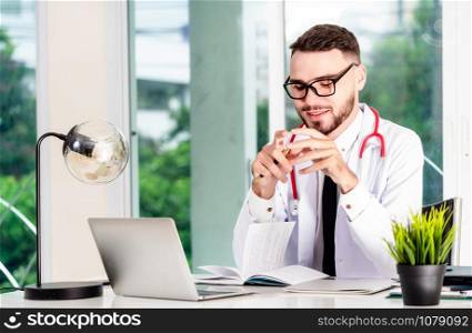 Doctor working on laptop computer at office table in the hospital. Medical and healthcare concept.