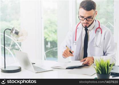 Doctor working on laptop computer at office table in the hospital. Medical and healthcare concept.. Doctor working on laptop computer hospital.