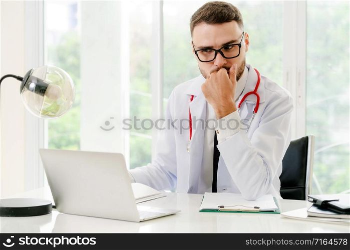 Doctor working on laptop computer at office table in the hospital. Medical and healthcare concept.. Doctor working on laptop computer hospital.