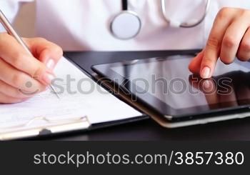 Doctor working on tablet computer