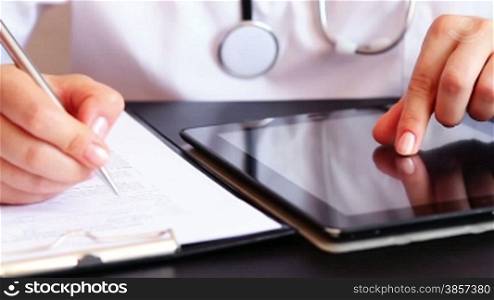 Doctor working on tablet computer