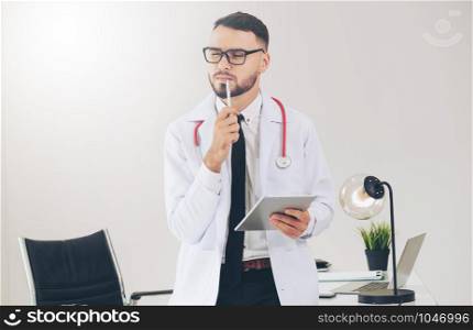 Doctor working on tablet computer at office in the hospital. Medical and healthcare concept.