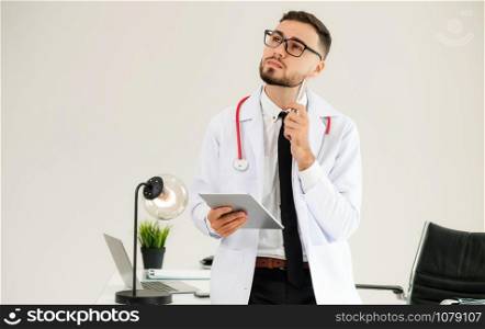 Doctor working on tablet computer at office in the hospital. Medical and healthcare concept.