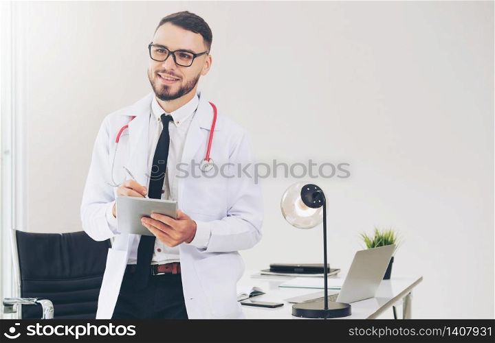 Doctor working on tablet computer at office in the hospital. Medical and healthcare concept.. Doctor working on tablet computer in the hospital.
