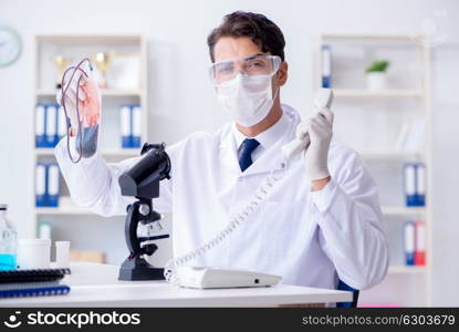 Doctor working with blood samples in hospital clinic lab