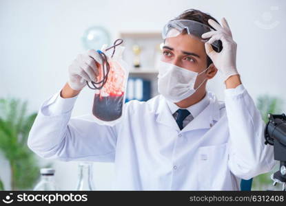 Doctor working with blood samples in hospital clinic lab. The doctor working with blood samples in hospital clinic lab