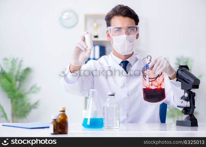 Doctor working with blood samples in hospital clinic lab. The doctor working with blood samples in hospital clinic lab