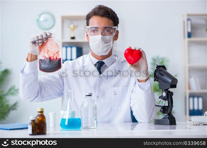 Doctor working with blood samples in hospital clinic lab. The doctor working with blood samples in hospital clinic lab