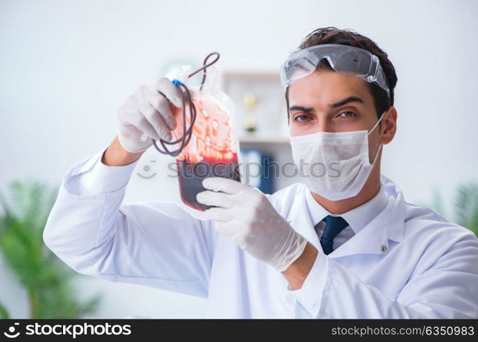 Doctor working with blood samples in hospital clinic lab