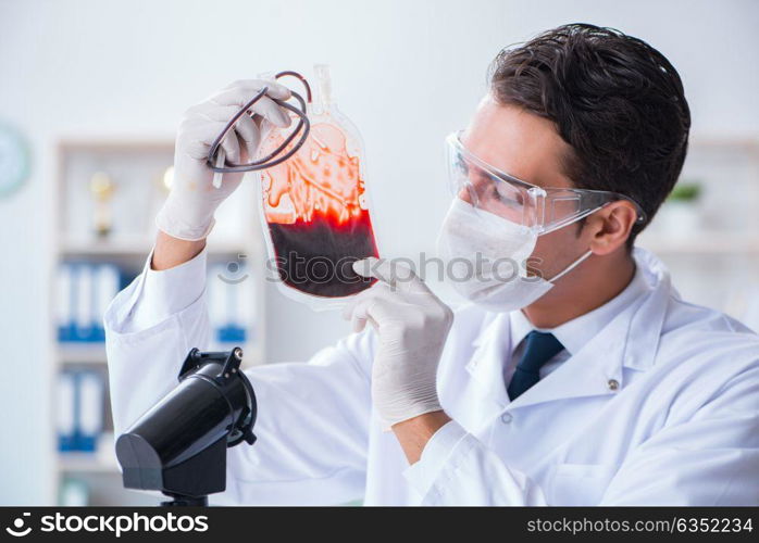 Doctor working with blood samples in hospital clinic lab. The doctor working with blood samples in hospital clinic lab