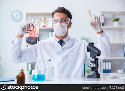 Doctor working with blood samples in hospital clinic lab