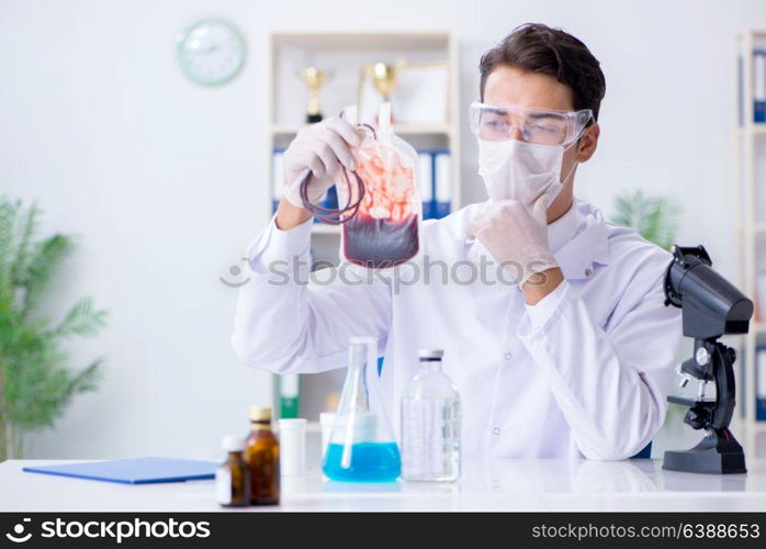 Doctor working with blood samples in hospital clinic lab