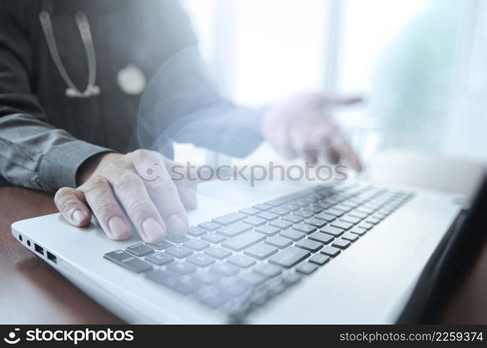 Doctor working with digital tablet and laptop computer in medical workspace office and overcast exposure effect