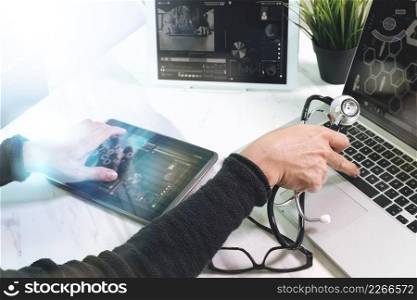 Doctor working with digital tablet and laptop computer with smart phone in medical workspace office and video conference as concept