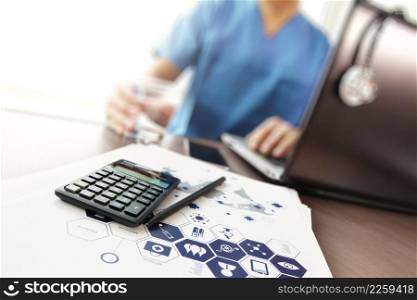Doctor working with laptop computer and calculater in medical workspace office and medical network media diagram as concept