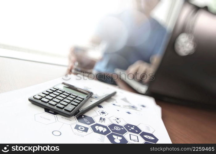 Doctor working with  laptop computer and calculater in medical workspace office and medical network media diagram as concept