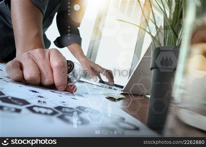 doctor working with laptop computer in medical workspace office and digital medical network media diagram layer with glass of water and green plant foreground as concept